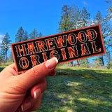 A hand holding a Harewood Original magnet  at Harewood Plains, Nanaimo. 