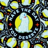 A pile of Have the Day You Deserve stickers.