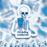 A pile of Stay Fucking Hydrated stickers. 