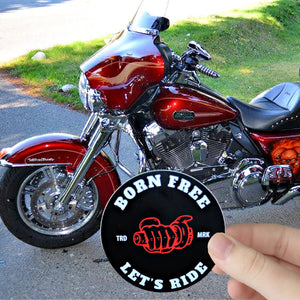 A Born Free Let's Ride sticker in front of a 2009 Harley Davidson TriGlide motorcycle. 