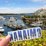 A pic of the Nanaimo harbour  with a Nanaimo sticker in front. 