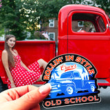 A Rollin' In Style Old School sticker in front of a classic pickup truck and a woman in a polka dot dress. 