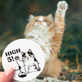 A furry kitty holding its paw up in the air over a hand holding a High 5! sticker. 