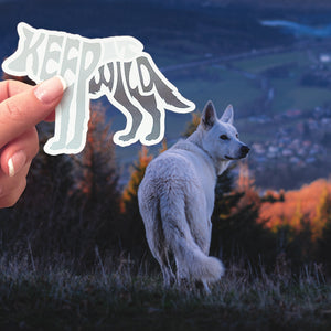 A Keep It Wild sticker behind a wolf. 