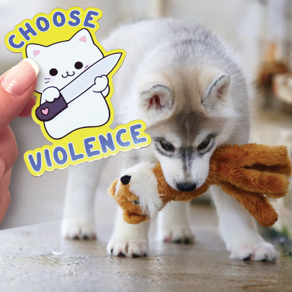 This is a cute Husky pup with a stuffed animal in it's mouth with a hand holding a Choose Violence sticker.