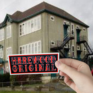 This is a picture of a Harewood Original sticker against a backdrop of the original Harewood School in Nanaimo, B.C. Canada.